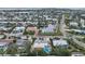 Aerial view of waterfront homes with private docks and easy ocean access, nestled among tropical trees and foliage at 504 69Th St, Holmes Beach, FL 34217