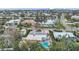 High-angle aerial view featuring lush, tropical landscaping, a large neighborhood, and boat-lined canals at 504 69Th St, Holmes Beach, FL 34217