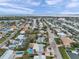 An aerial perspective of a waterfront community featuring homes with backyard pools, lush foliage, and boat access at 504 69Th St, Holmes Beach, FL 34217