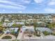 Panoramic aerial shot capturing a neighborhood with tropical landscaping, a blend of homes, and a glimpse of the distant ocean at 504 69Th St, Holmes Beach, FL 34217
