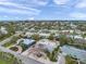 An aerial view showcases a charming residential area with palm trees and colorful homes under a bright, cloudy sky at 504 69Th St, Holmes Beach, FL 34217