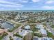 A bird's eye view of a community showcasing homes with pools and boat docks set against a stunning waterfront backdrop at 504 69Th St, Holmes Beach, FL 34217