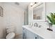 Bright bathroom features a white vanity with gray cabinets, walk-in shower with stylish tile, and modern fixtures at 504 69Th St, Holmes Beach, FL 34217