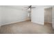 Bright bedroom featuring light tile flooring, a ceiling fan, and an open doorway to a walk-in closet at 504 69Th St, Holmes Beach, FL 34217