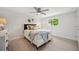 Cozy bedroom features a comfortable queen bed, modern ceiling fan, and plenty of natural light from a large window at 504 69Th St, Holmes Beach, FL 34217