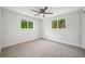 Bright and airy bedroom boasts a modern ceiling fan and two large windows at 504 69Th St, Holmes Beach, FL 34217
