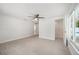 Bright bedroom with light tile flooring, a ceiling fan, and a door to a walk-in closet, creating a relaxing atmosphere at 504 69Th St, Holmes Beach, FL 34217