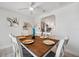 Bright dining room with a wood table, white chairs, and a view into the kitchen area at 504 69Th St, Holmes Beach, FL 34217
