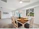 Dining area with a wood table and six chairs with a large window overlooking the outdoors at 504 69Th St, Holmes Beach, FL 34217