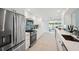 Modern kitchen features stainless steel appliances, white cabinetry, and quartz countertops at 504 69Th St, Holmes Beach, FL 34217