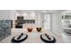 Bright kitchen features white cabinets and counters with stainless steel appliances at 504 69Th St, Holmes Beach, FL 34217
