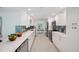 Beautiful kitchen with white cabinets, stainless steel appliances, and tile backsplash at 504 69Th St, Holmes Beach, FL 34217