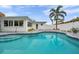 Beautiful backyard pool showcasing the building's white exterior and well-kept landscaping at 504 69Th St, Holmes Beach, FL 34217