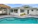 Backyard pool showcasing patio, building's exterior, and surrounding lush landscaping at 504 69Th St, Holmes Beach, FL 34217