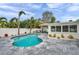 Backyard pool featuring elegant stone tiling, tropical foliage, and a charming gazebo at 504 69Th St, Holmes Beach, FL 34217