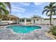 Backyard oasis with sparkling pool, covered patio, and tropical landscaping, perfect for outdoor enjoyment at 504 69Th St, Holmes Beach, FL 34217