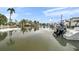 Gorgeous waterfront view with boats, docks, and tropical landscaping, perfect for boaters at 504 69Th St, Holmes Beach, FL 34217