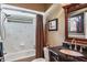 Well-lit bathroom with a shower-tub combination, framed art, and a marble vanity at 5269 Karlsburg Pl, Palm Harbor, FL 34685
