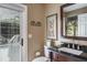 Bathroom featuring a door to the outside, vanity, and plenty of natural light at 5269 Karlsburg Pl, Palm Harbor, FL 34685