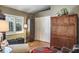 Bedroom featuring a closet, natural light, wooden floors, and warm, stylish decor at 5269 Karlsburg Pl, Palm Harbor, FL 34685