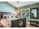 Cozy bedroom with natural light, framed wall decor, and hardwood flooring at 5269 Karlsburg Pl, Palm Harbor, FL 34685
