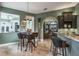 Cozy breakfast nook with a round table and bar seating overlooking the kitchen at 5269 Karlsburg Pl, Palm Harbor, FL 34685