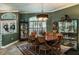 Elegant dining room with a large table, sophisticated chandelier, and tasteful decor at 5269 Karlsburg Pl, Palm Harbor, FL 34685