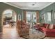 Cozy living room featuring elegant seating, arched doorway, and access to the outdoor patio at 5269 Karlsburg Pl, Palm Harbor, FL 34685