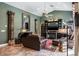Spacious living room featuring comfortable seating, decorative columns, and a cozy fireplace at 5269 Karlsburg Pl, Palm Harbor, FL 34685