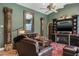 Comfortable living room with stylish columns, leather furniture, and a decorative fireplace at 5269 Karlsburg Pl, Palm Harbor, FL 34685