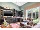 Inviting living room with a fireplace, built-in shelving, and lots of natural light at 5269 Karlsburg Pl, Palm Harbor, FL 34685