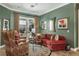 Inviting living room with comfortable seating, stylish decor, and access to a patio view at 5269 Karlsburg Pl, Palm Harbor, FL 34685