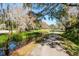 A serene pond and walking path meander through the community at 5269 Karlsburg Pl, Palm Harbor, FL 34685