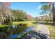 Enjoy a leisurely walk on the paved path meandering by the serene pond at 5269 Karlsburg Pl, Palm Harbor, FL 34685
