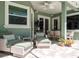 Outdoor patio with ceiling fan, seating area, and dining table with a television mounted on the wall at 5269 Karlsburg Pl, Palm Harbor, FL 34685