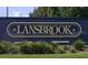 A Lansbrook Community sign provides directions to the neighborhood at 5269 Karlsburg Pl, Palm Harbor, FL 34685