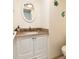 Well-lit bathroom vanity area with granite countertop, white cabinets, and decorative fish accents at 5575 Gulf Blvd # 421, St Pete Beach, FL 33706