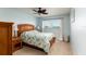 Cozy bedroom featuring a wooden bed frame, soft bedding, and a window with a view at 5575 Gulf Blvd # 421, St Pete Beach, FL 33706
