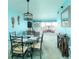 Coastal dining area featuring a unique chandelier, dining table, and bright blue walls at 5575 Gulf Blvd # 421, St Pete Beach, FL 33706