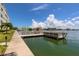 Waterfront community dock with seating and water views under a bright, sunny sky at 5575 Gulf Blvd # 421, St Pete Beach, FL 33706