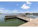 Community waterfront dock, featuring railings and water views, under a bright sky at 5575 Gulf Blvd # 421, St Pete Beach, FL 33706