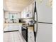 Bright kitchen featuring white cabinets, stainless steel appliances, and ample counter space at 5575 Gulf Blvd # 421, St Pete Beach, FL 33706