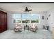 Bright living room features two patterned armchairs and large windows with city views at 5575 Gulf Blvd # 421, St Pete Beach, FL 33706