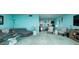 Inviting living room with a gray sectional sofa, glass coffee tables, and elegant decor leading to the dining area at 5575 Gulf Blvd # 421, St Pete Beach, FL 33706