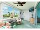 Bright sitting room with city views, cozy chairs, and a television, perfect for relaxation at 5575 Gulf Blvd # 421, St Pete Beach, FL 33706
