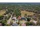 Scenic aerial view of a home with a pool in a lush, established neighborhood surrounded by mature trees and ponds at 5807 Thoreau Pl, Lithia, FL 33547