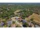 Picturesque aerial view of a home featuring a pool in a neighborhood with mature trees and well-maintained landscaping at 5807 Thoreau Pl, Lithia, FL 33547
