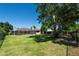 Large, well-maintained backyard featuring a screened lanai, mature trees, and secure fencing at 5807 Thoreau Pl, Lithia, FL 33547