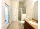 Bright bathroom with walk-in shower and door to exterior at 5807 Thoreau Pl, Lithia, FL 33547