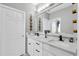 Modern bathroom with double vanity, new fixtures, white cabinets, quartz countertops and decor at 5807 Thoreau Pl, Lithia, FL 33547